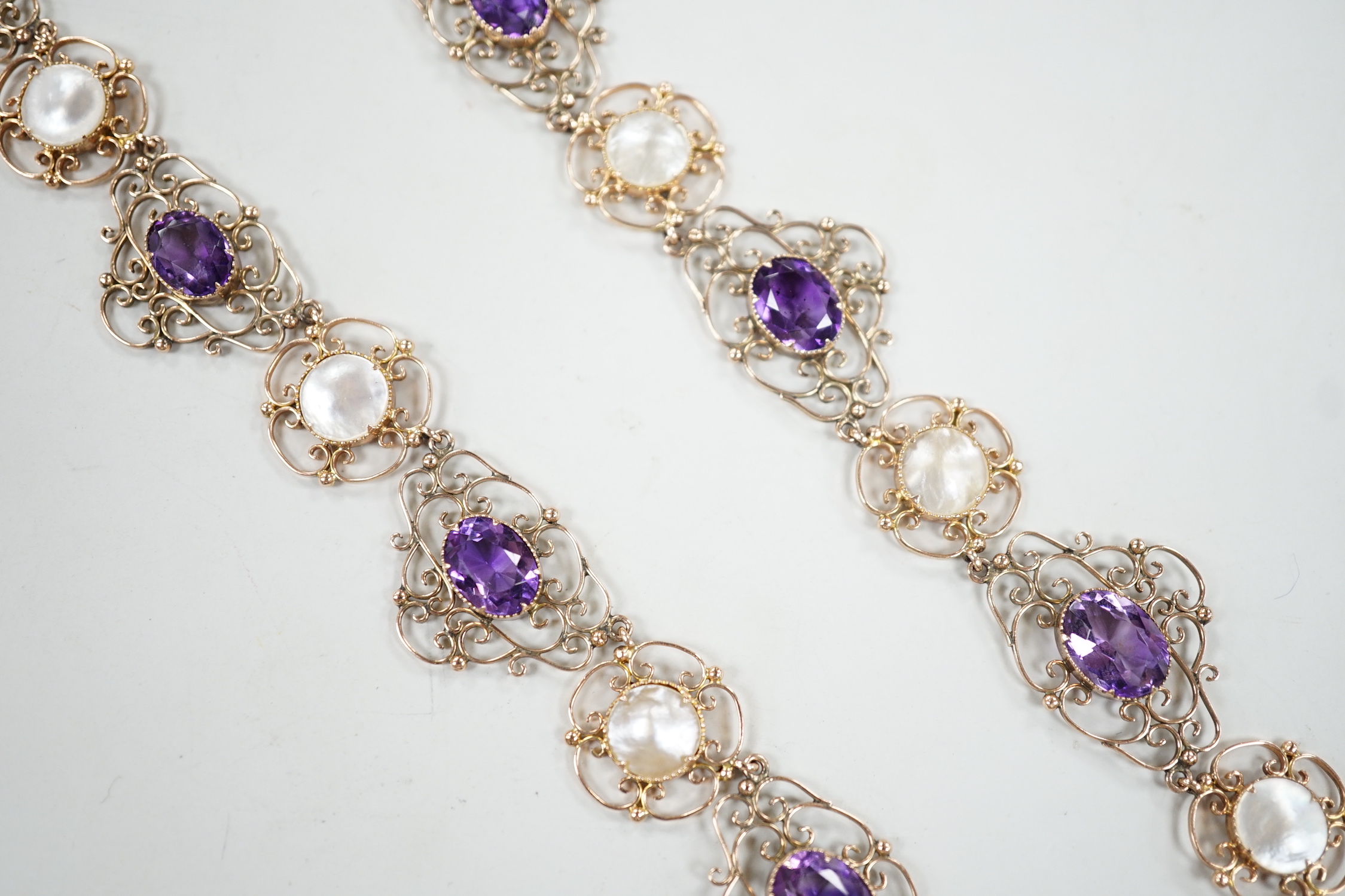 An Edwardian yellow metal, amethyst and mother-of-pearl set drop necklace, 44cm, gross weight 29.5 grams.